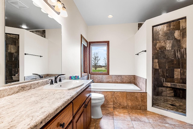 full bath with toilet, tiled bath, vanity, and a tile shower