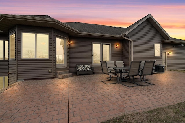 patio terrace at dusk with central AC and entry steps