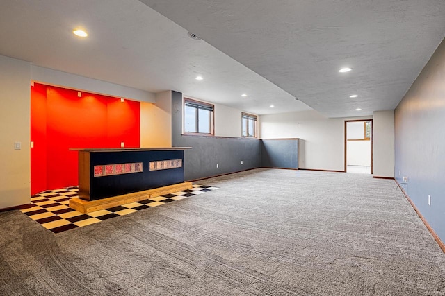 below grade area with baseboards, carpet flooring, indoor bar, and recessed lighting