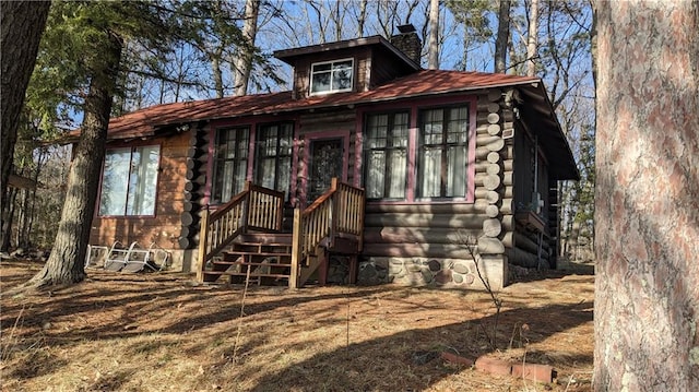 6051 Elsie Rd, Stone Lake, WI 54876 - view of front of house featuring a chimney and log siding