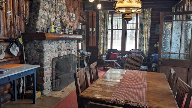 6051 Elsie Rd, Stone Lake, WI 54876 - dining room featuring log walls and a stone fireplace