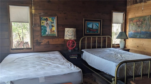 6051 Elsie Rd, Stone Lake, WI 54876 - bedroom featuring wood walls and multiple windows