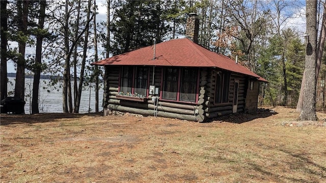6051 Elsie Rd, Stone Lake, WI 54876 - cabin featuring log exterior, a sunroom, a chimney, and a front lawn