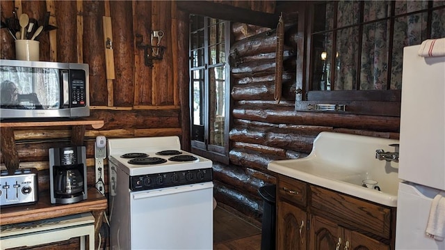 6051 Elsie Rd, Stone Lake, WI 54876 - kitchen with white appliances, log walls, and a sink
