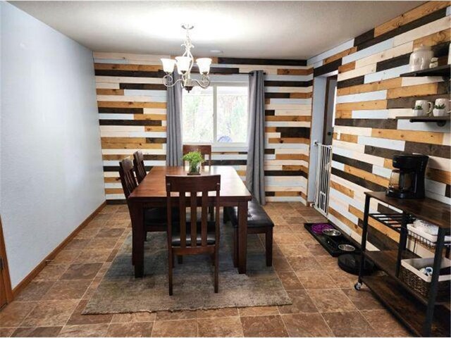 21 N Main St, Luck, WI 54853 - dining area with stone finish floor and an inviting chandelier