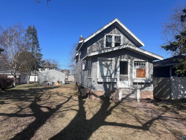view of front of house with a chimney and entry steps