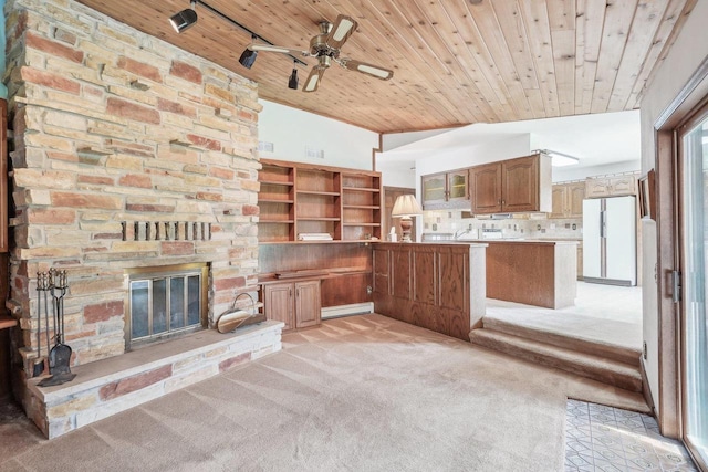 unfurnished living room with wood ceiling, a ceiling fan, a stone fireplace, light colored carpet, and a baseboard heating unit