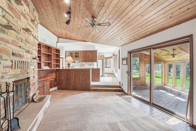 unfurnished living room with light carpet, baseboard heating, a stone fireplace, a ceiling fan, and wood ceiling