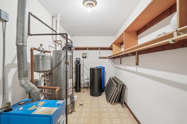 utility room with water heater and a heating unit