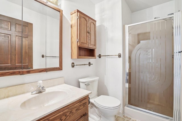full bathroom with vanity, toilet, and a shower stall