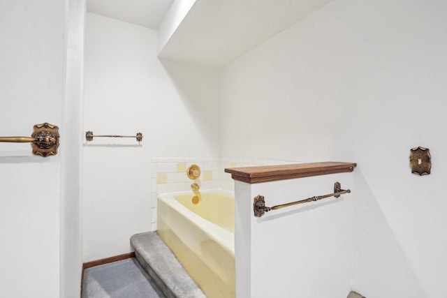 full bathroom with baseboards and a bath