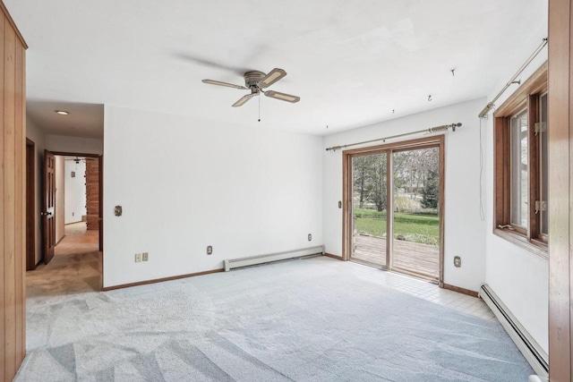empty room featuring baseboards, ceiling fan, baseboard heating, and light colored carpet