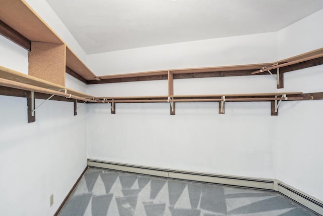 walk in closet featuring carpet floors and baseboard heating