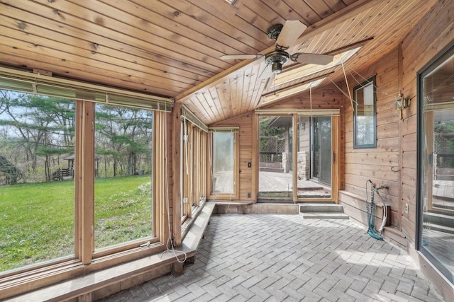 unfurnished sunroom featuring a healthy amount of sunlight and a ceiling fan
