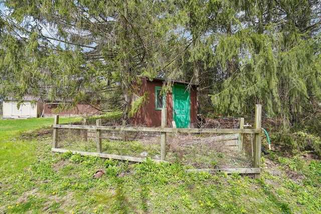 view of shed featuring fence