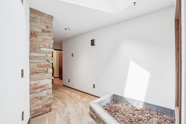 interior space featuring baseboards, light colored carpet, and visible vents