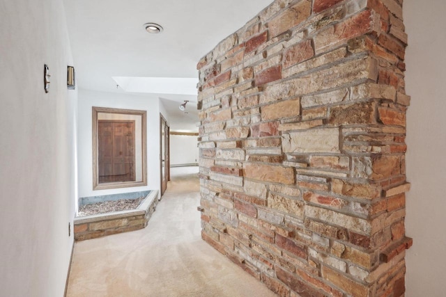 hallway featuring carpet flooring and a skylight