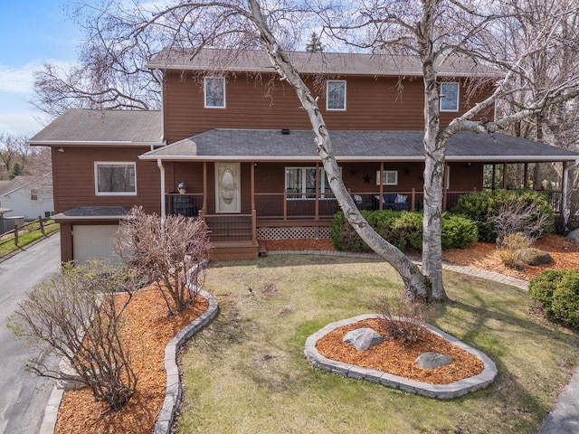 view of front of house featuring a garage, roof with shingles, a front lawn, and covered porch