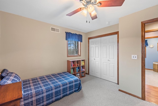 bedroom with a ceiling fan, a closet, visible vents, and carpet