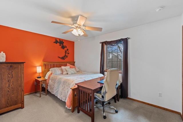 bedroom with light carpet, a ceiling fan, and baseboards