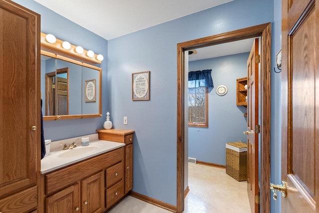 bathroom featuring baseboards, visible vents, tile patterned floors, and vanity