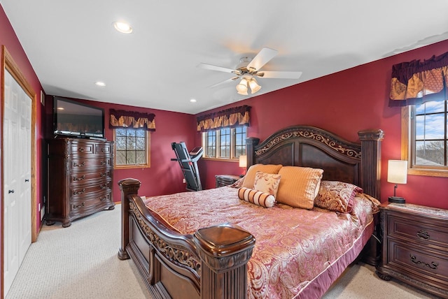 bedroom featuring light carpet, a ceiling fan, multiple windows, and recessed lighting