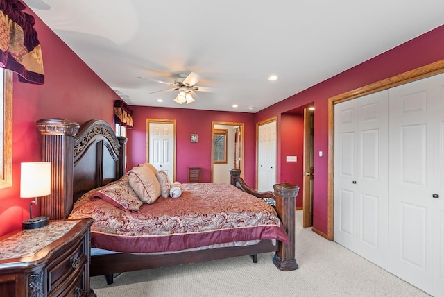 bedroom with recessed lighting, multiple closets, a ceiling fan, and light carpet