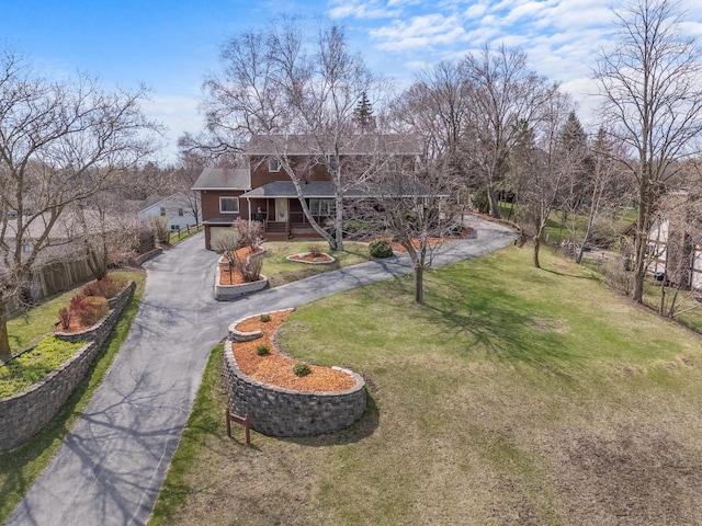 exterior space with a porch, driveway, and a front yard