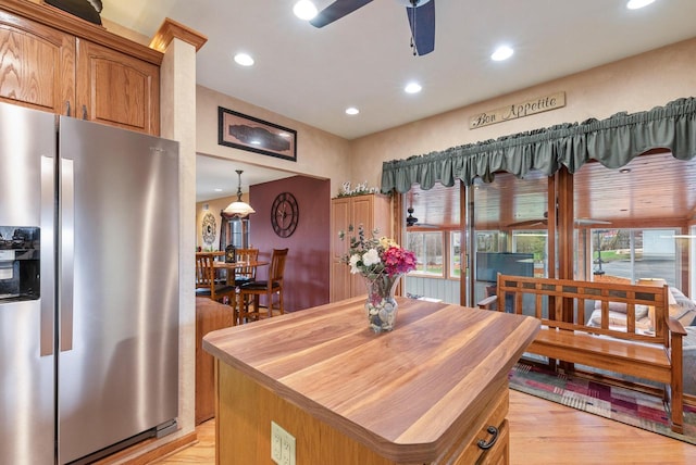kitchen with stainless steel refrigerator with ice dispenser, a ceiling fan, light wood-style floors, and recessed lighting