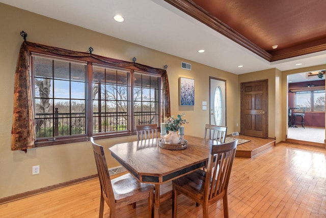 dining room featuring baseboards, visible vents, recessed lighting, light wood-style floors, and crown molding