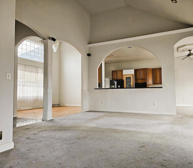 1835 N Davies Dr, Summit, WI 53066 - unfurnished living room with light carpet, vaulted ceiling, baseboards, and a ceiling fan