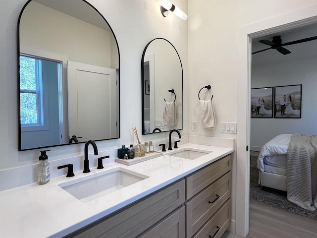 3156 Breeze Dr, Sun Prairie, WI 53590 - bathroom featuring ensuite bath, wood finished floors, a sink, and double vanity