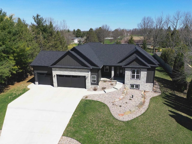 3156 Breeze Dr, Sun Prairie, WI 53590 - view of front of house with stone siding, driveway, a front yard, and a garage