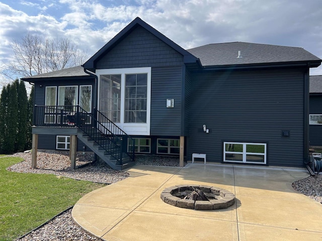 3156 Breeze Dr, Sun Prairie, WI 53590 - back of property with a fire pit, a patio area, a lawn, stairway, and a sunroom