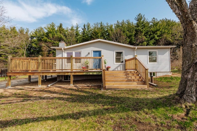 W2252 Spring Lake Rd, Markesan, WI 53946 - back of property featuring a lawn, a chimney, and a deck