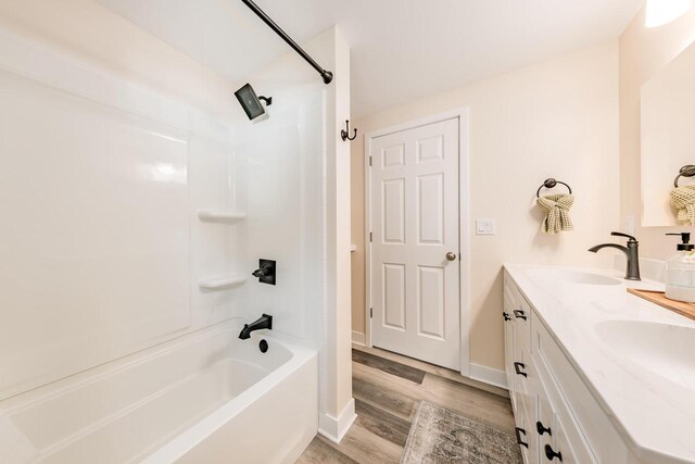 W2252 Spring Lake Rd, Markesan, WI 53946 - bathroom with bathtub / shower combination, wood finished floors, double vanity, and a sink