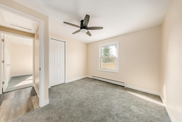 W2252 Spring Lake Rd, Markesan, WI 53946 - unfurnished bedroom with a baseboard radiator, a closet, attic access, carpet, and baseboards