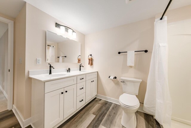 W2252 Spring Lake Rd, Markesan, WI 53946 - full bath with toilet, wood finished floors, a sink, and double vanity