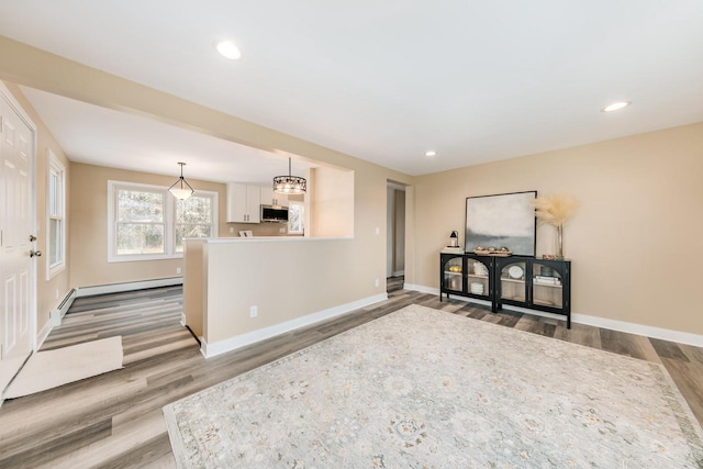 W2252 Spring Lake Rd, Markesan, WI 53946 - interior space with baseboard heating, baseboards, wood finished floors, and recessed lighting