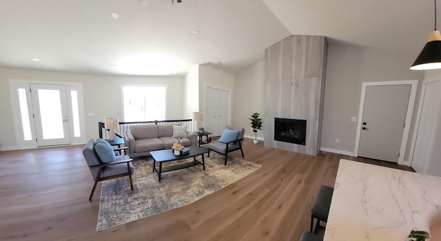 365 13th Dr, Nekoosa, WI 54457 - living room with lofted ceiling, wood finished floors, baseboards, and a large fireplace