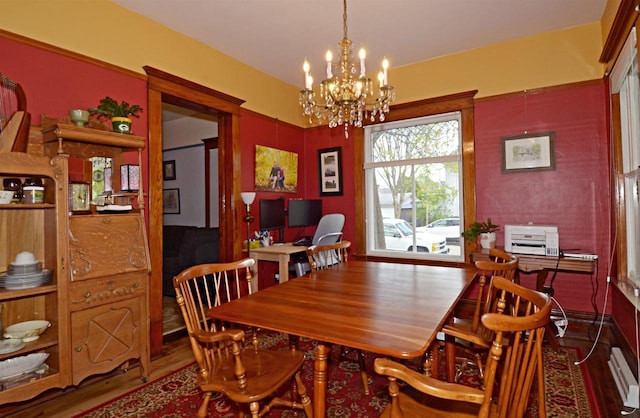 301 Van Buren St, Sauk City, WI 53583 - dining space featuring a baseboard heating unit, a chandelier, and wood finished floors