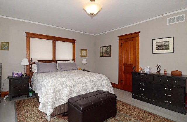 301 Van Buren St, Sauk City, WI 53583 - bedroom with light wood finished floors, visible vents, and ornamental molding