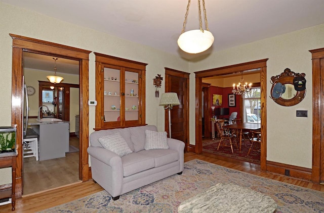 301 Van Buren St, Sauk City, WI 53583 - living room featuring a chandelier and wood finished floors
