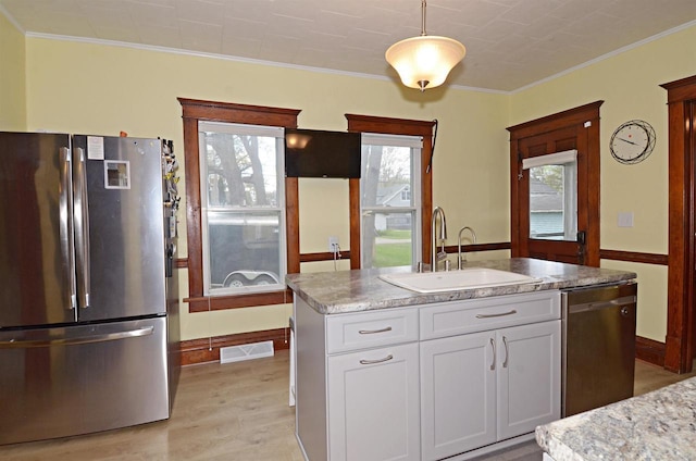 301 Van Buren St, Sauk City, WI 53583 - kitchen with white cabinetry, a wealth of natural light, appliances with stainless steel finishes, and a sink