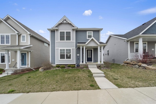 5872 Tranquility Trl, Madison, WI 53718 - view of front of property featuring board and batten siding, a porch, and a front lawn