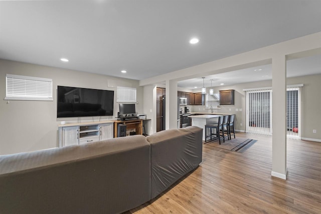 5872 Tranquility Trl, Madison, WI 53718 - living room with light wood-type flooring, baseboards, and recessed lighting