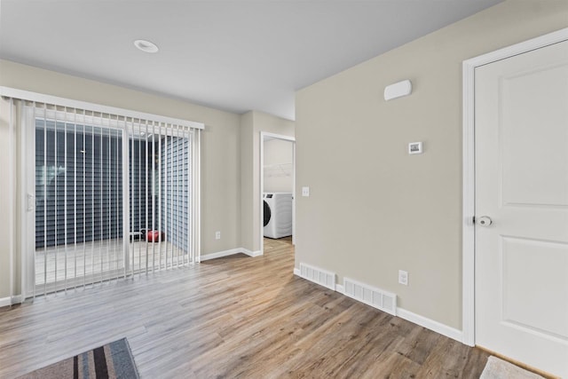 5872 Tranquility Trl, Madison, WI 53718 - unfurnished room featuring washer / dryer, wood finished floors, visible vents, and baseboards
