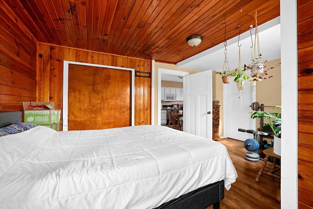 bedroom featuring wood finished floors, wood walls, and wood ceiling