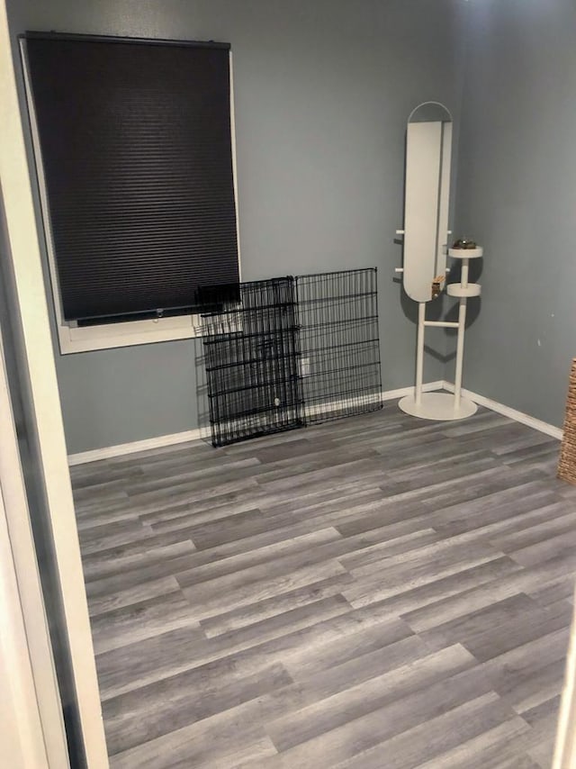 empty room featuring baseboards and wood finished floors