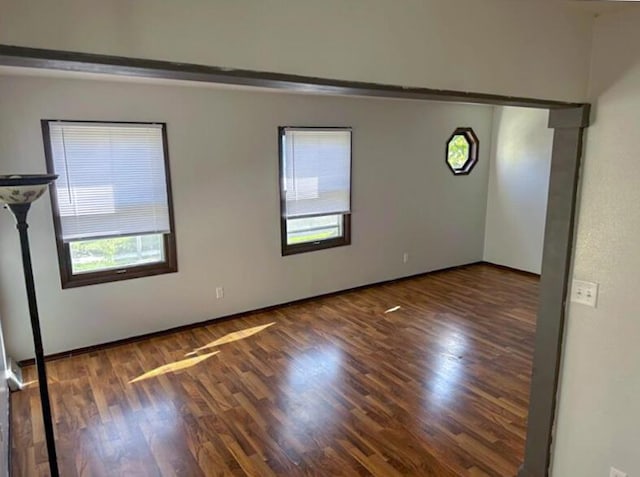 empty room with wood finished floors and baseboards
